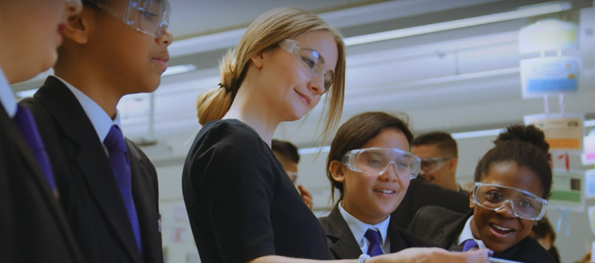 A teacher demonstrates a chemical reaction to some students